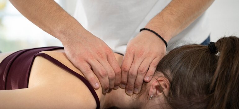 Physiotherapist helping patient with rehabilitation exercises